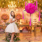 pink piñata at quinceañera party with girl in white dress