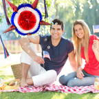 couple sitting outside on picnic blanket, with american usa flag and red, white, and blue pinata